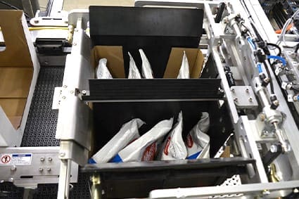 Bags being loaded into cases